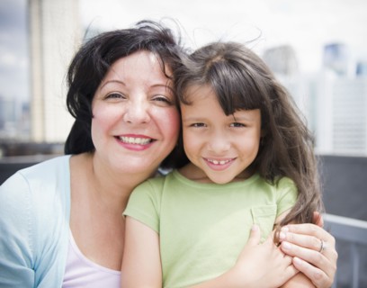 Hispanic mother and daughter hugging