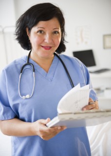 Hispanic doctor looking at medical chart