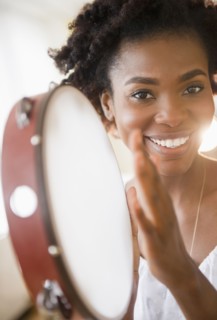 Black woman holding tambourine
