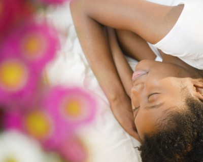 Black woman sleeping on bed