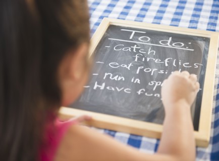 Korean girl writing to do list on blackboard