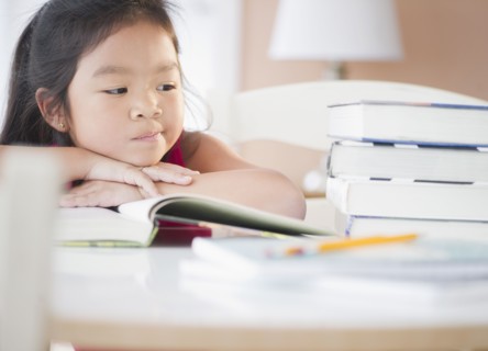Bored Korean girl doing homework