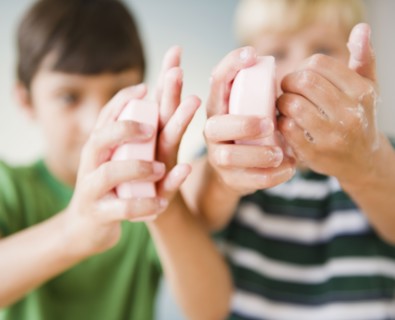 Boys washing their hands with soap
