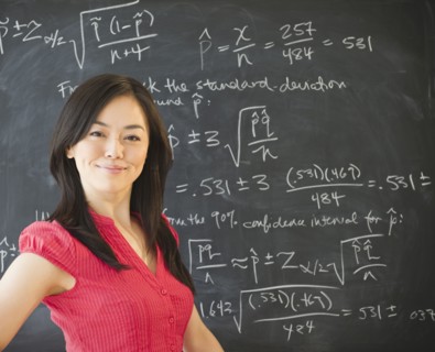 Japanese teacher standing near blackboard