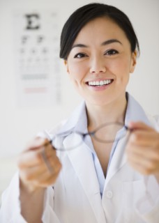 Japanese optometrist holding eyeglasses