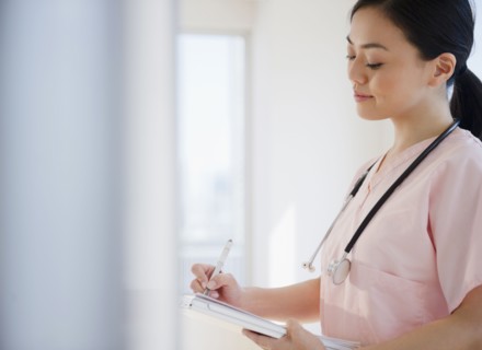 Japanese nurse writing on medical record