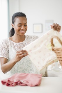 Black woman folding laundry