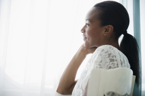 Smiling Black woman thinking