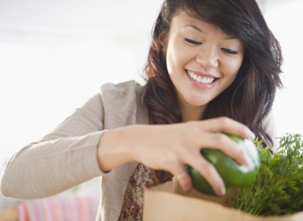 Pacific Islander woman taking groceries from grocery bag
