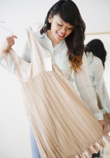 Pacific Islander woman looking at dress in store