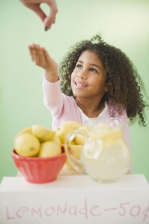 Mixed race girl with lemonade stand