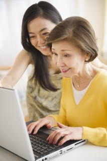 Japanese mother and daughter using laptop together