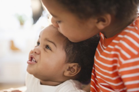 Black boy hugging sister