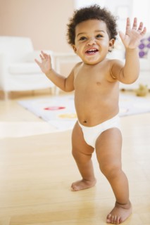 Black baby girl learning to walk