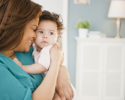 Mixed race mother snuggling baby