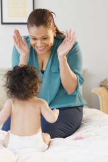 Mixed race mother playing with baby