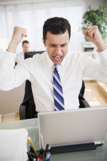 Angry mixed race businessman shouting in laptop