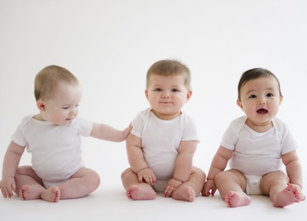 Three babies sitting on floor