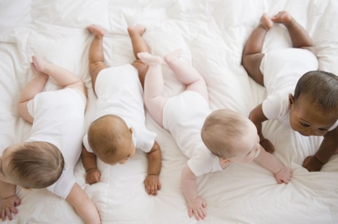 Babies laying on floor together