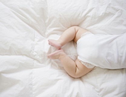 Mixed race baby boy laying on floor