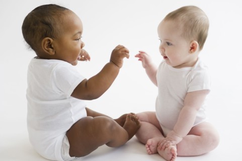 Babies playing together on floor