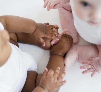 Babies sitting together on floor