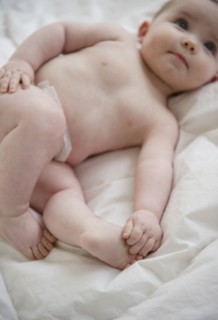 Caucasian baby girl laying on blanket