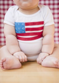Caucasian baby boy in onesie with American flag on it