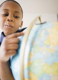 Black boy looking at globe