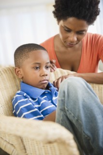 Black mother comforting son