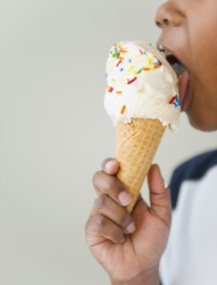 Black boy licking ice cream cone