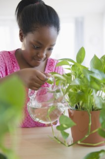 Black girl watering plants