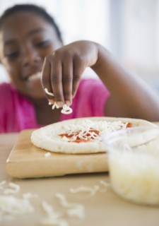Black girl making pizza