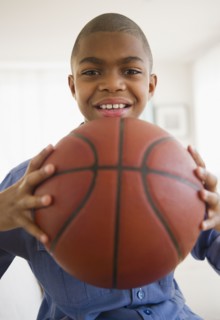 African American boy holding basketball