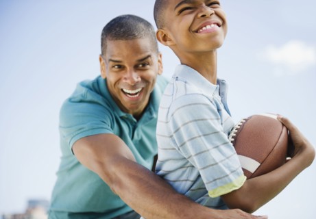 Father and son playing football