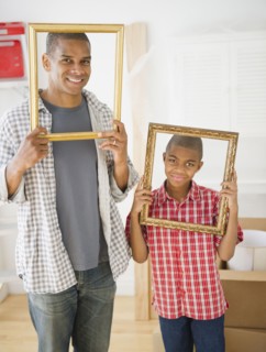 Father and son looking through empty frames