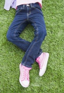 Mixed race girl laying on grass