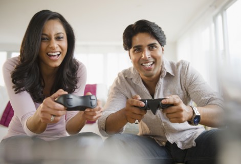 Mixed race couple playing video game