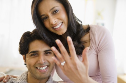 Mixed race woman showing off engagement ring