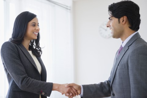 Mixed race business people shaking hands