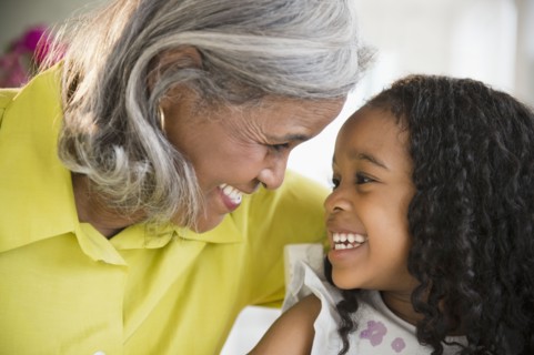 Smiling African American grandmother and granddaughter