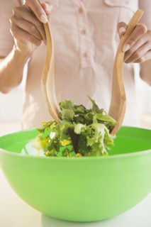 Cape Verdean woman tossing a salad