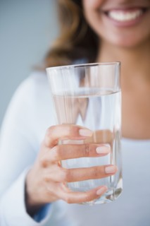 Cape Verdean woman holding glass of water