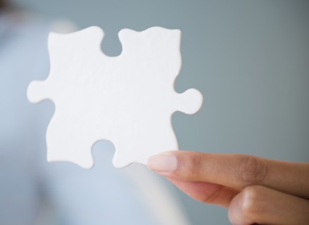 Cape Verdean woman holding puzzle piece