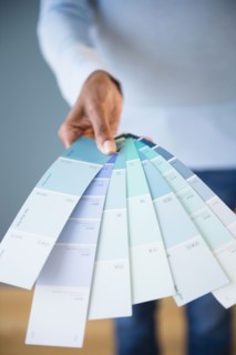 Cape Verdean woman holding color swatches