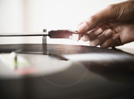 Cape Verdean woman listening to vinyl record