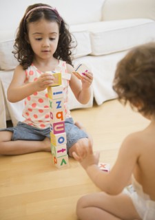 Mixed race children playing with blocks