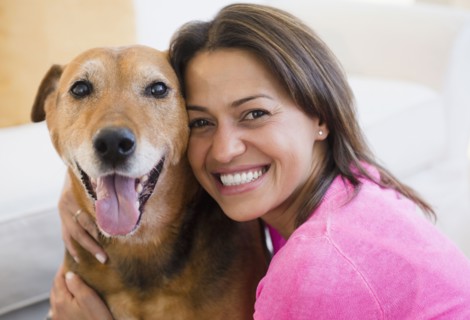 Hispanic woman hugging dog