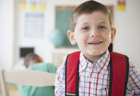 Smiling Caucasian boy in classroom