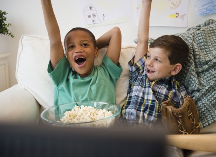 Boys eating popcorn and cheering